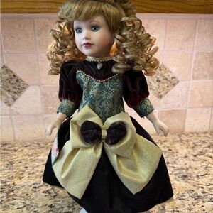 Melissa Porcelain Doll with Gold and Brown Dress, curly hair.
